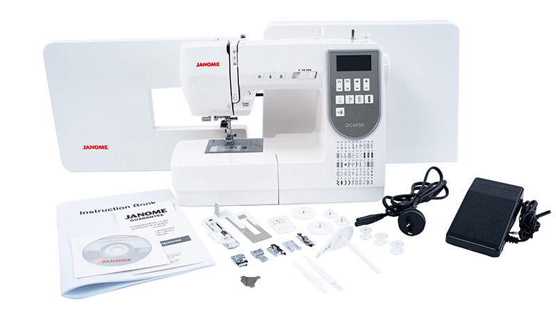 Janome DC6050 machine with included feet, extension table, hard cover, foot controller and accessories