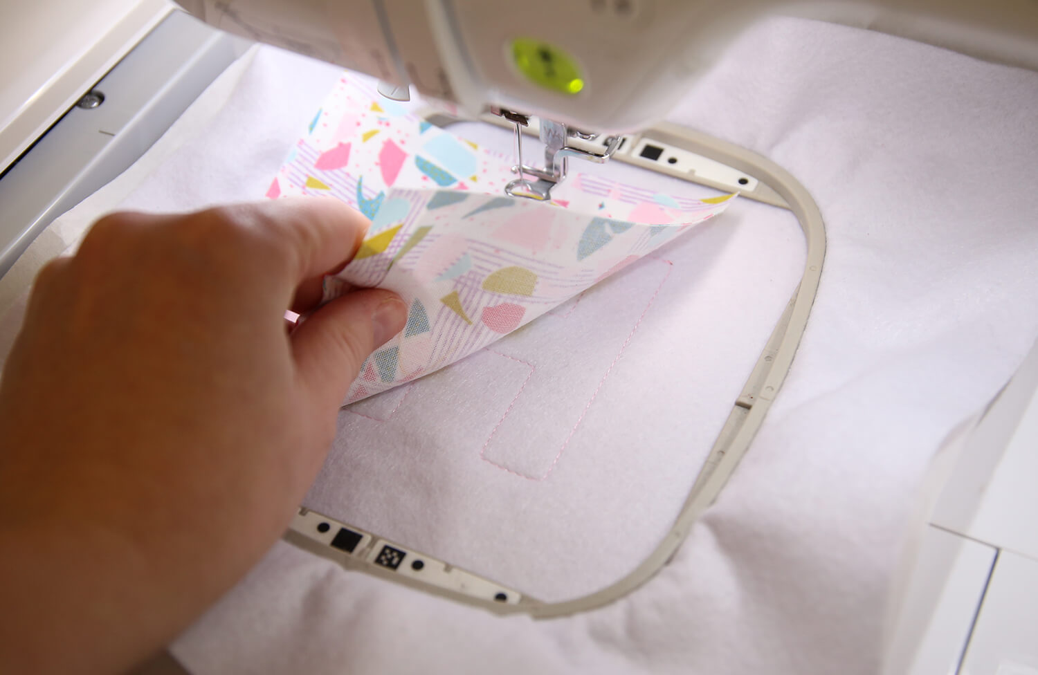 Applique fabric placed over the stitched placement outline on felt