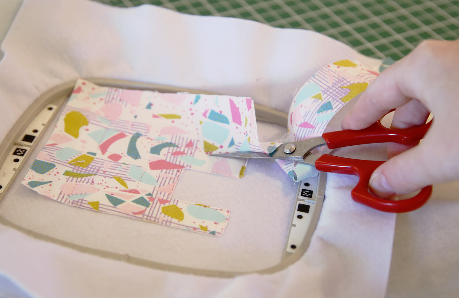 Trimming applique fabric close to the stitching using applique scissors