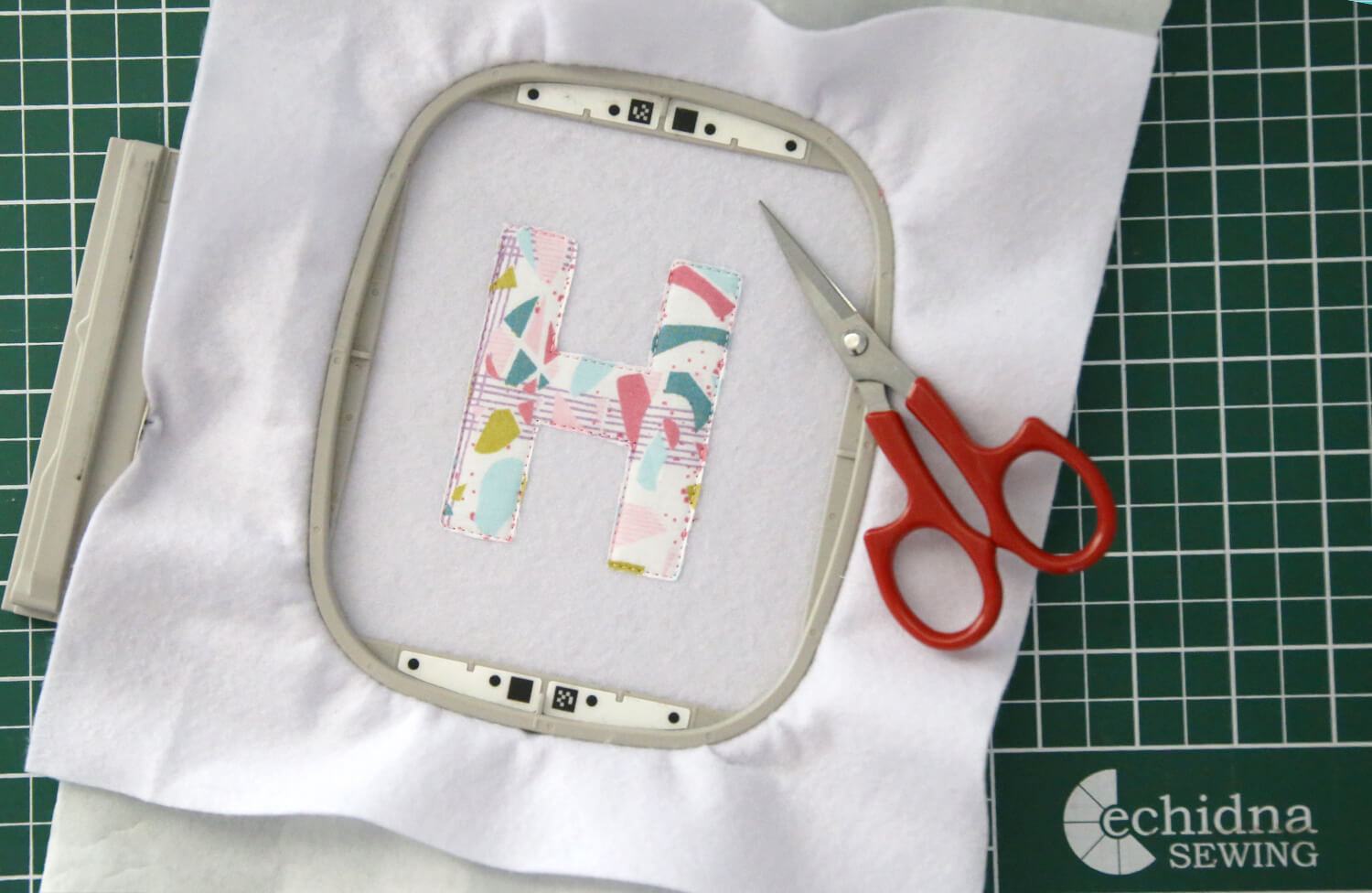 Trimming applique fabric close to the stitching using applique scissors