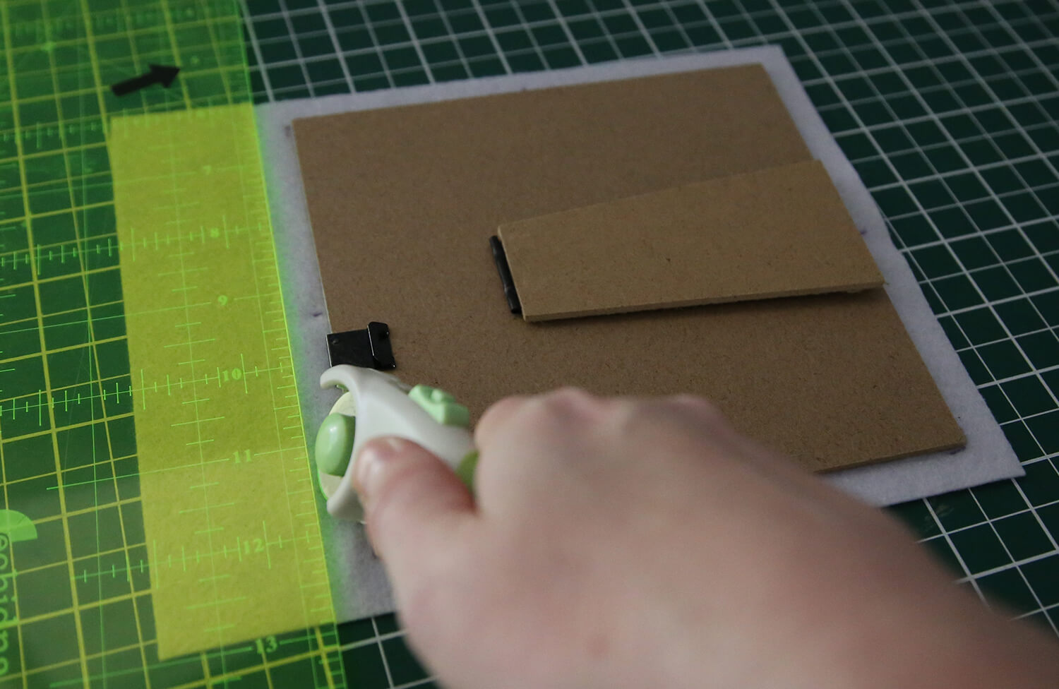 Trimming excess felt around the backing board edges