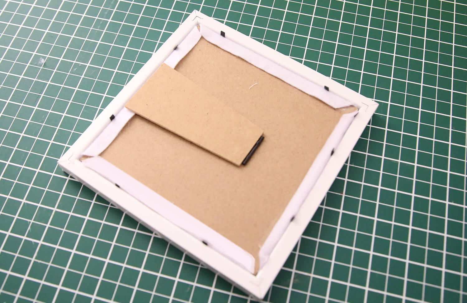 Assembling the finished applique artwork into the photo frame