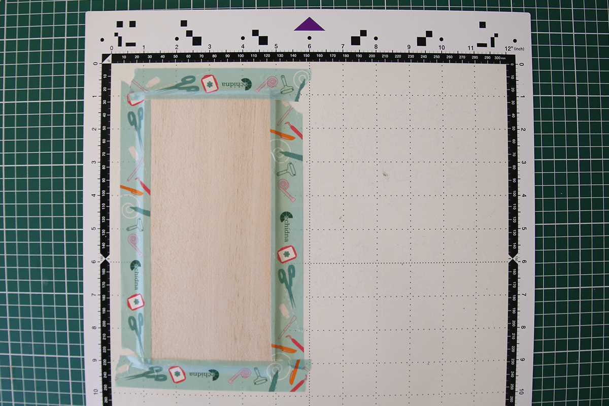 Tape balsa wood to mat
